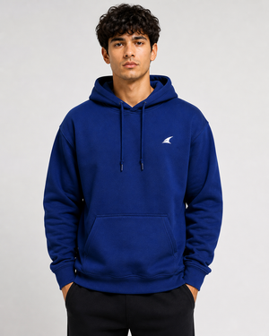 Man wearing a blue hoodie with a logo on a gray background