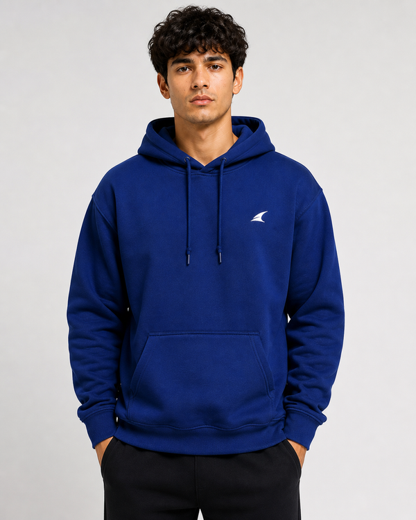 Man wearing a blue hoodie with a logo on a gray background